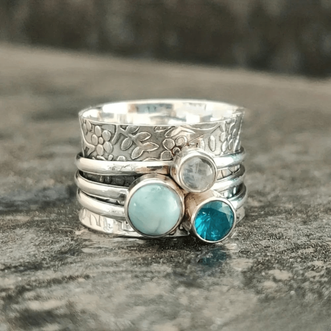 Handcrafted Floral Silver Spinner Ring with Blue Gemstones - Ring